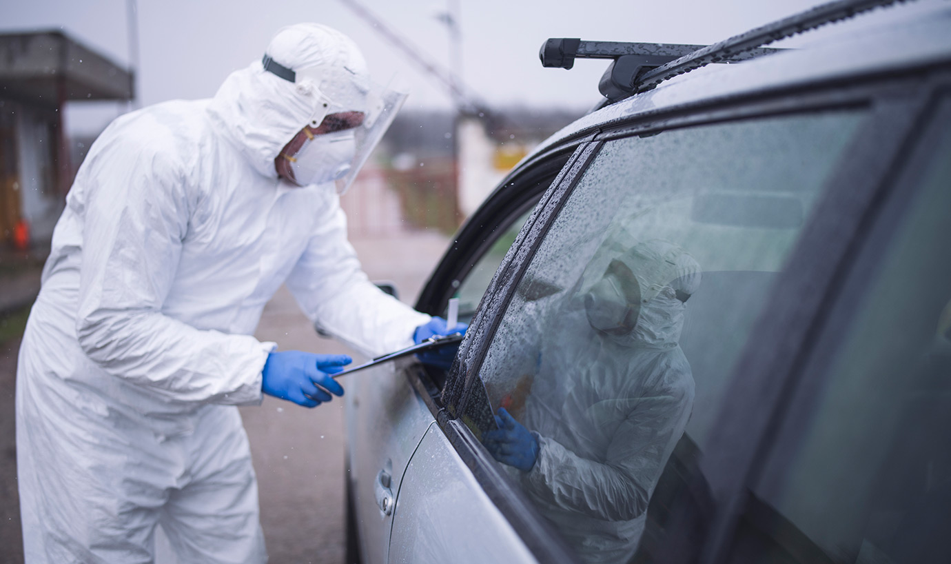 Health care worker in Tyvek suit